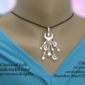 May include: A silver-toned pendant featuring a cluster of crescent moons and stars suspended from a black cord. The text on the image reads: Choice of fully adjustable cord or various lengths and Choice of over 48 cord colours or Stainless Steel Chain.