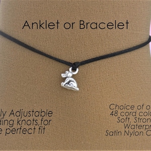 May include: A black cord anklet or bracelet featuring a silver-toned dog charm. The jewellery includes sliding knots for adjustment. Text on the image reads: Anklet or Bracelet, Fully Adjustable sliding knots, for the perfect fit, Choice of over 48 cord colours, Soft, Strong & Waterproof, Satin Nylon Cord.