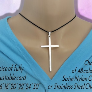May include: A silver cross pendant necklace on a black adjustable cord. The cord is available in 48 colours or a stainless steel chain. The cord lengths are 16, 18, 20, 22, 24, and 30 inches.