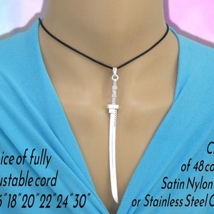 May include: A silver-colored sword pendant hanging on a black cord. The text on the image reads: Choice of fully adjustable cord or 16" 18" 20" 22" 24" 30" and Choice of 48 colours Satin Nylon Cord or Stainless Steel Chain.