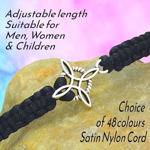 May include: Black satin nylon cord bracelet with a silver-colored decorative centerpiece. The text on the image says "Adjustable length Suitable for Men, Women & Children" and "Choice of 48 colours Satin Nylon Cord".