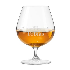 May include: A clear brandy glass filled with amber liquid. The glass is engraved with the name "Tobias" and the words "BEST QUALITY". The glass has a wide bowl and a stemmed base, perfect for enjoying spirits.