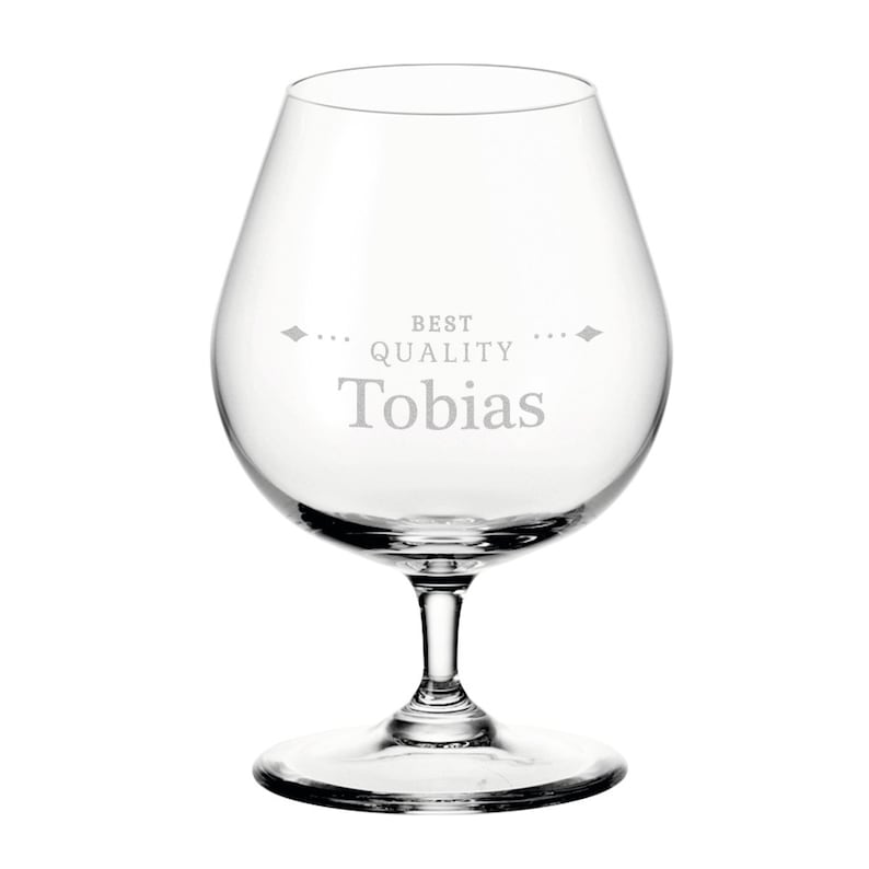 May include: A clear brandy glass with a rounded bowl and a stem. The words "BEST QUALITY Tobias" are etched on the glass. Ideal for brandy or other spirits, this glass is a classic design.