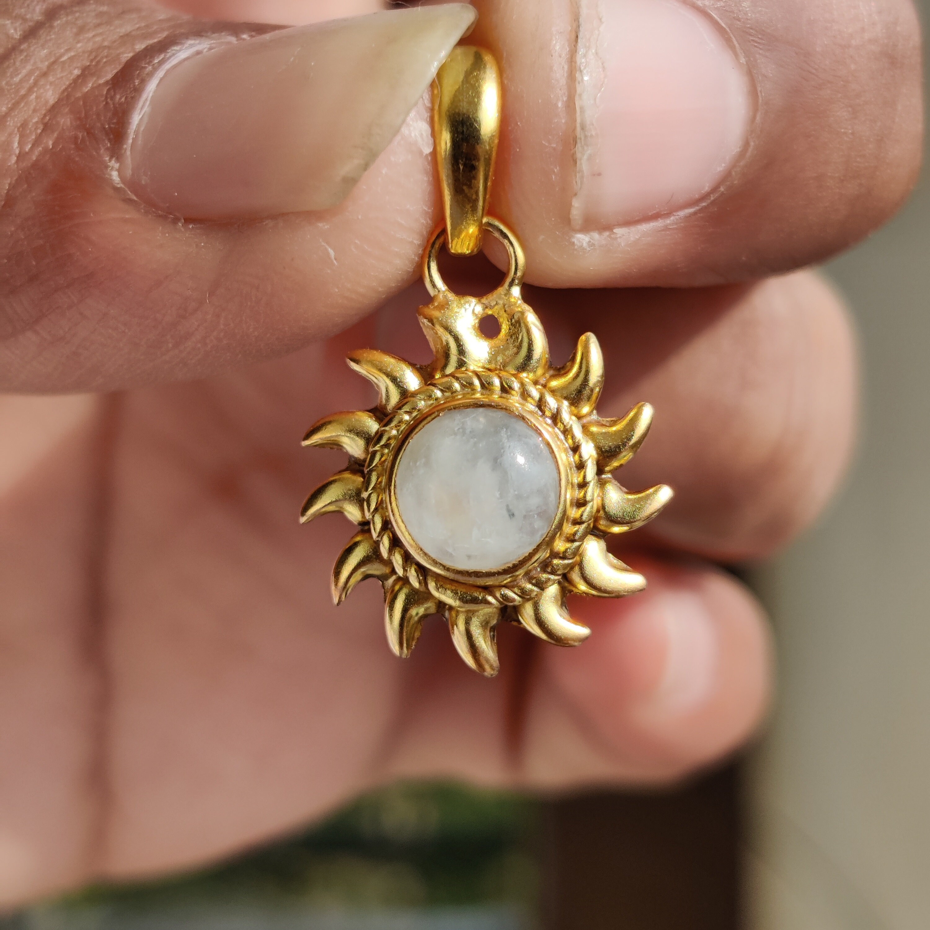 Sun shaped gold pendant deals