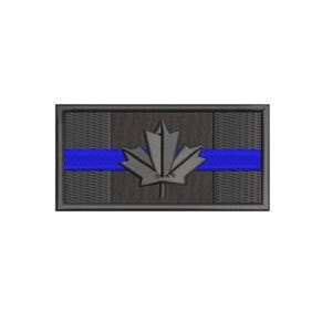 May include: Black and grey embroidered patch featuring a Canadian maple leaf and a blue stripe across the centre. The patch is rectangular and has a black border.