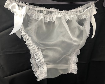 May include: White lace trimmed sheer lingerie with satin bows on each side.