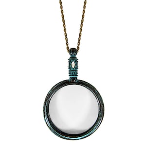 May include: A vintage-style magnifying glass pendant necklace with a bronze-colored chain. The magnifying glass has a circular frame with a teal patina finish. The word "Patina" is printed at the bottom.