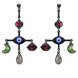 May include: Matte black earrings with a dangling evil eye charm, a red lip charm, a green crescent moon charm, and a teardrop charm.