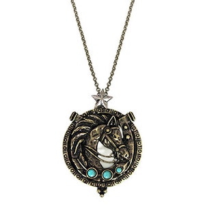 May include: Gold-toned necklace with a round pendant featuring a horse head design with turquoise accents. The pendant has a star charm at the top and is surrounded by a circular inscription.