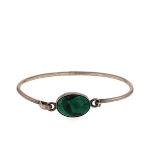 May include: A silver bangle bracelet with a green malachite stone.