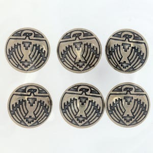 May include: Six silver-toned buttons with a black and white design of a stylized bird. The design is geometric and includes a bird with outstretched wings.