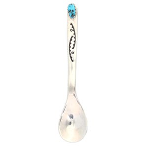 May include: A silver spoon with a turquoise stone at the top of the handle. The handle is decorated with a geometric design.