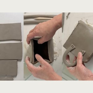 May include: A person is making a clay box with a handle. The box is made of brown clay and has a rectangular shape. The handle is made of clay and is shaped like a loop. The person is using their hands to shape the clay.