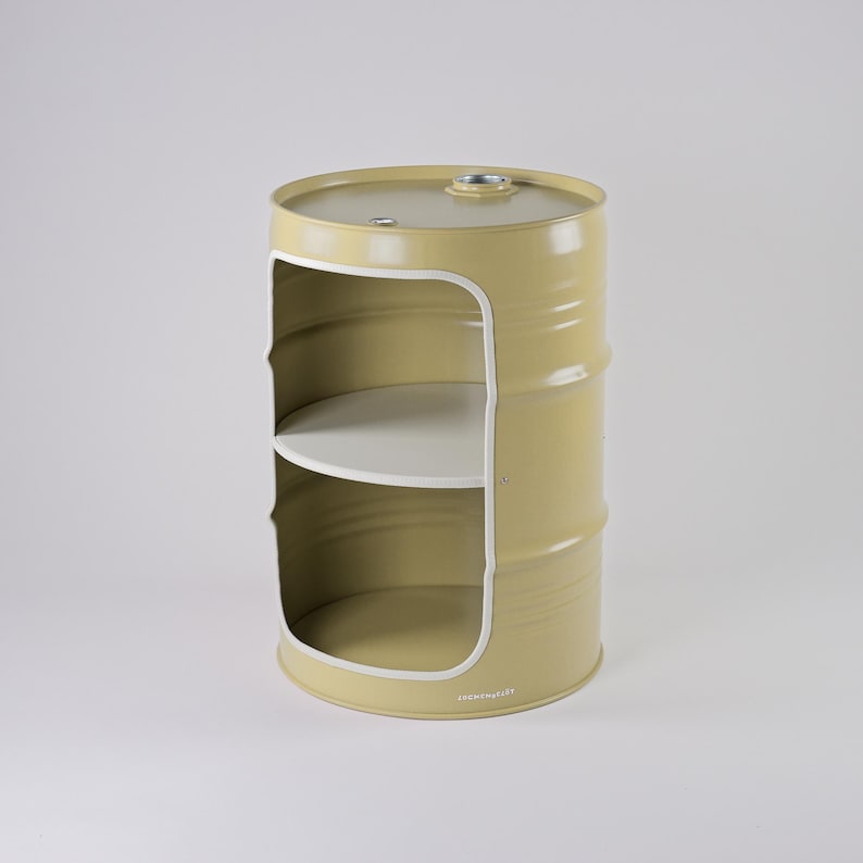 May include: A yellow metal barrel-shaped storage unit with two white shelves. The unit has a large opening on the front with a white trim. The top of the barrel has a small metal fitting. The unit is on a white background.