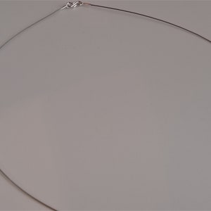 May include: A silver chain necklace with a clasp closure.