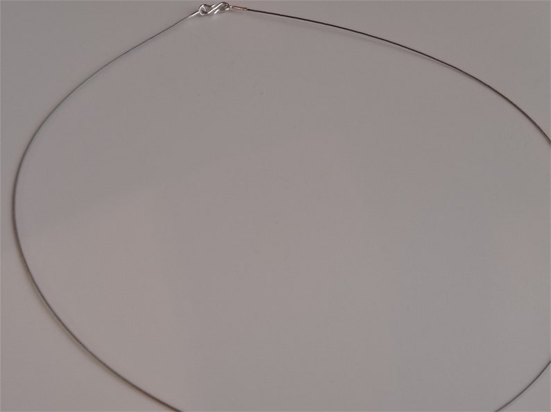 May include: A silver chain necklace with a clasp closure.