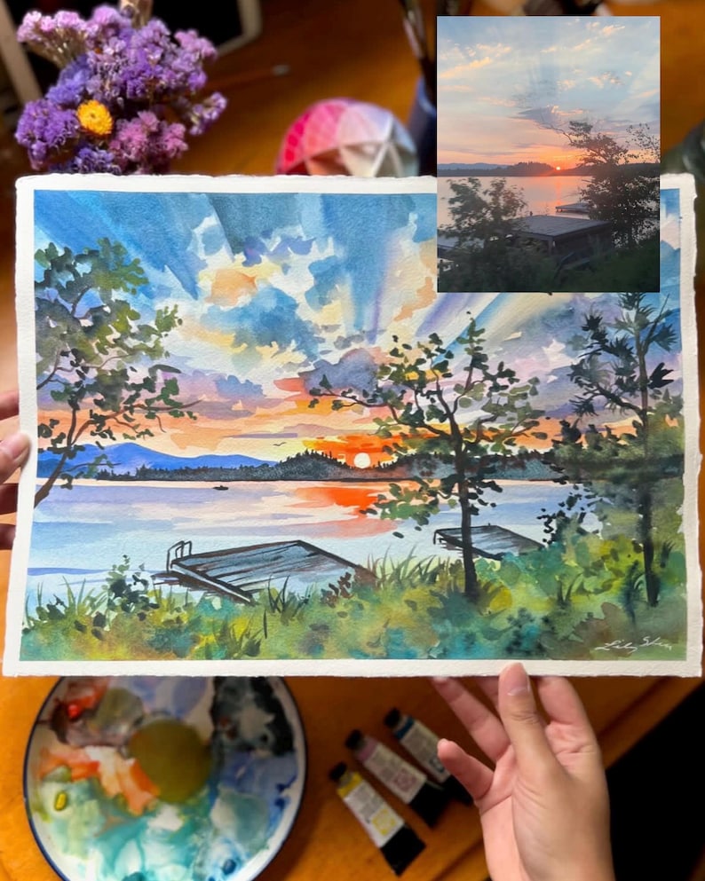Puede incluir: Una pintura de acuarela de una puesta de sol sobre un lago con un muelle en primer plano. El cielo es de un naranja y rosa vibrantes, con nubes que se reflejan en el agua. Los &aacute;rboles est&aacute;n silueteados contra la puesta de sol.