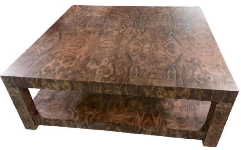 May include: A square coffee table constructed from wood with a prominent burl grain pattern. The table features a flat top surface and a lower shelf supported by four thick, straight legs, showcasing a rich brown color with swirling wood grain.