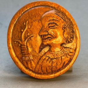 Hand carved Boxwood charm of a Caucasian man in medieval clothes, holds a flower, unusual motif, rare