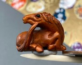 1 Hand carved Boxwood ojime of a seated horse, year of the horse, signed by artist