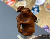 1 Hand carved Boxwood ojime of a rabbit holding a mushroom, wood bunny bead, year of the Hare, signed by artist