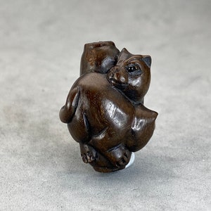 One hand carved teakwood ojime: cat, dark wood cat bead, wood cat bead, fine details, wood cat toggle, hand carved and signed by the carver