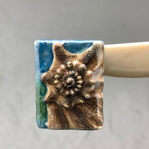 1 Porcelain charm: Rectangular bead painted seashell