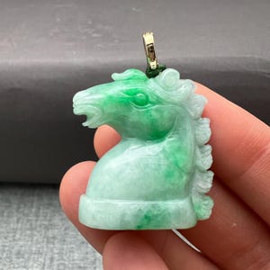 Jade charm: One hand carved jade and jadeite pendant of a horse head, symbol of fidelity and strength, noble steed, natural color fei cui