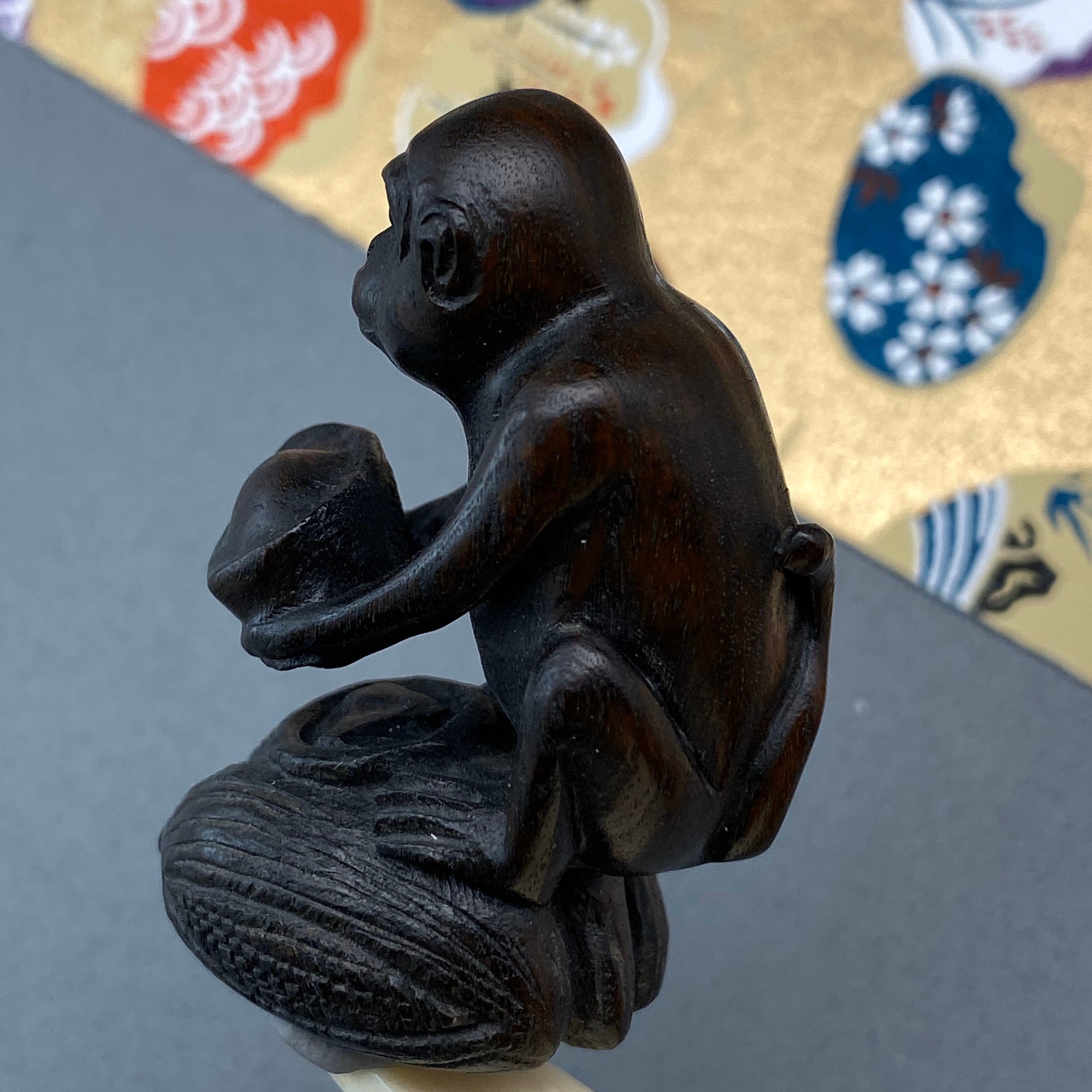Hand Carved Teakwood Netsuke: Monkey Seated on Bread of Corn