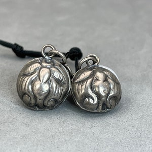 Sterling silver charm: a pair of hand made sterling silver charm of a peach, symbol of longevity, good health, well polished, silver peach