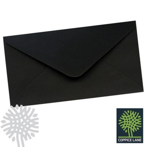 May include: Black envelope with a standard flap. The envelope is made of a smooth, matte paper.