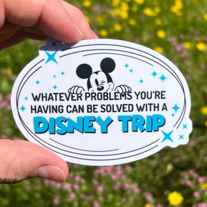 May include: White oval sticker with a black outline. Mickey Mouse is peeking over the top of the sticker. The text reads "Whatever problems you're having can be solved with a Disney Trip".