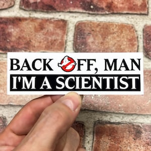 May include: White sticker with black text that reads "Back off, man I'm a scientist". A red circle with a diagonal line through it contains a white ghost figure.