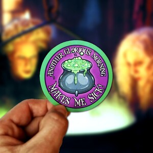 May include: A purple and green round sticker with a cauldron filled with green liquid and the text "Another Glorious Morning Makes Me Sick!"