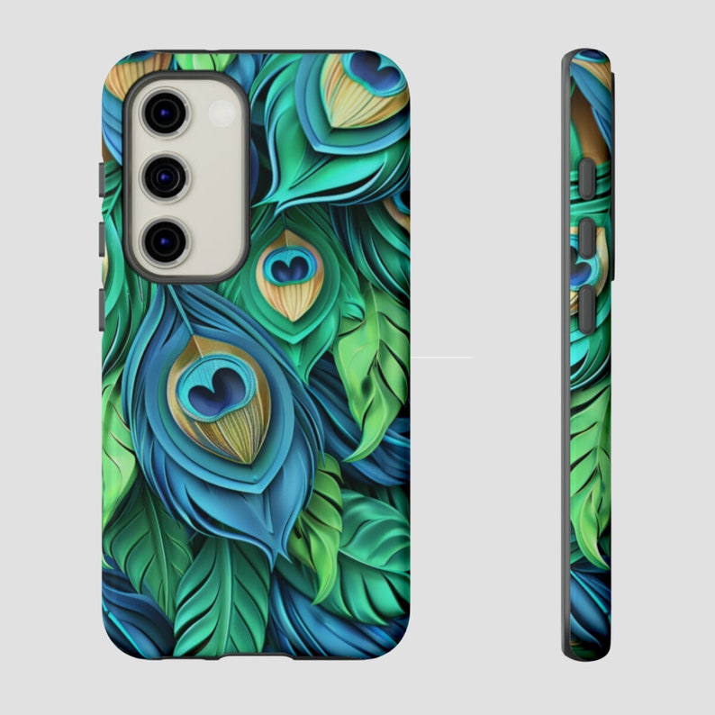 May include: A phone case with a peacock feather design. The case is black with a green and blue peacock feather pattern.
