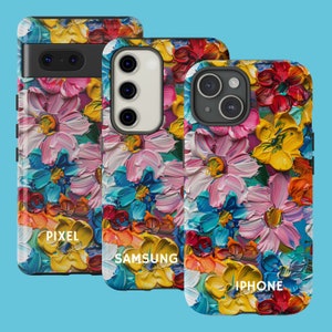 May include: Three phone cases with a colorful floral design. The cases are for Pixel, Samsung, and iPhone phones. The design features a variety of flowers in shades of pink, blue, yellow, and red.