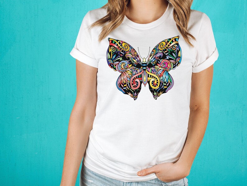 A woman wearing a white t-shirt with a colorful butterfly design on it.