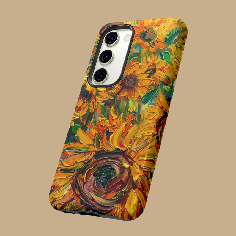 May include: A phone case featuring a vibrant sunflower design. The case showcases a close-up of sunflowers in various shades of yellow, orange, and brown, painted in a thick, textured style.
