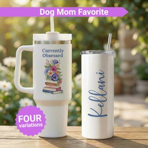 May include: Two white insulated tumblers with lids and straws. One has a handle and the text "Currently Obsessed" with a floral and book design. The other has the name "Kellani" in blue script. The image also includes the text "Dog Mom Favorite" and "FOUR variations".