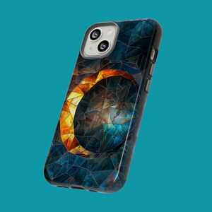 May include: A black phone case with a mosaic design featuring a crescent moon shape in shades of orange and blue.