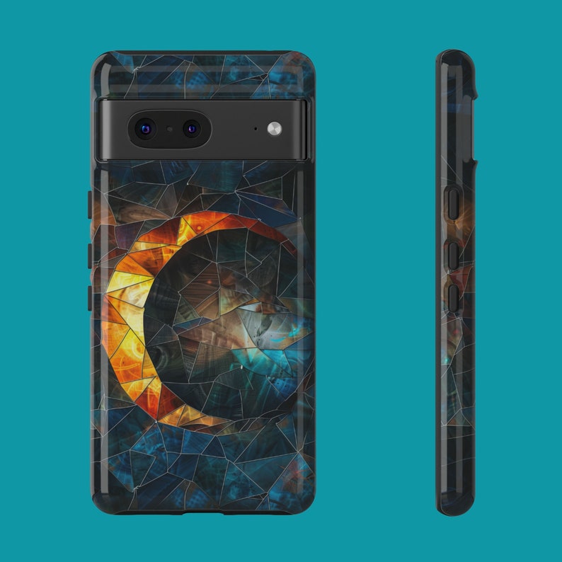 May include: A black phone case with a mosaic design featuring a crescent moon in shades of orange, yellow, and blue.
