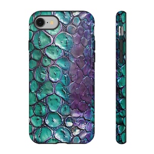 May include: A phone case with a colorful abstract design featuring teal, purple, and silver tones. The design resembles a textured, organic pattern.