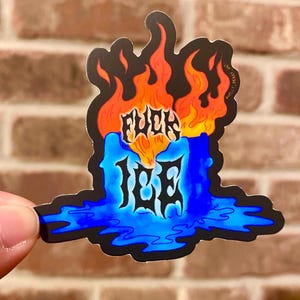 May include: A sticker with a blue candle design, featuring the text "FUCK ICE" in stylized lettering. The candle has orange flames at the top and a blue wax base. The sticker is held by a hand.