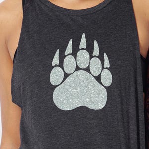 May include: A dark grey tank top with a silver glitter bear paw print design.