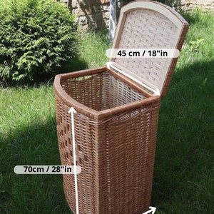 May include: A brown wicker laundry basket with a lid. The basket is 28 inches tall, 14 inches wide, and 18 inches deep.