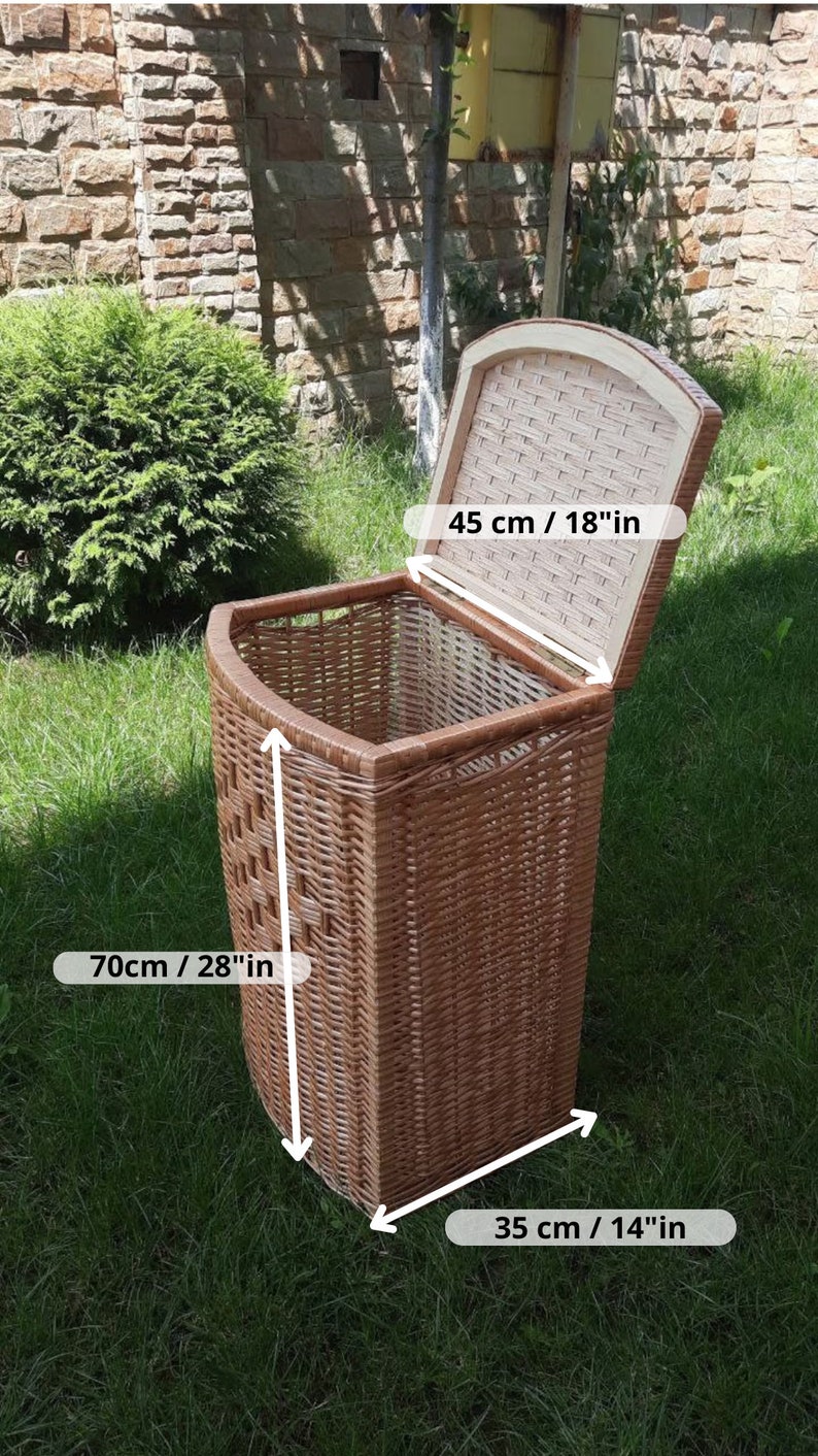 May include: A brown wicker laundry basket with a lid. The basket is 28 inches tall, 14 inches wide, and 18 inches deep.