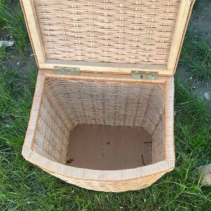 May include: A woven wicker storage basket with a hinged lid. The basket is open and the inside is empty.