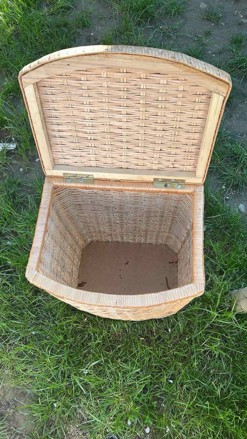May include: A woven wicker storage basket with a hinged lid. The basket is open and the inside is empty.