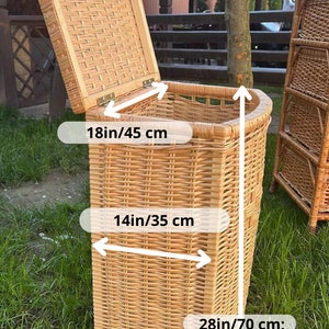 May include: A large wicker storage basket with a lid. The basket is 28 inches tall, 14 inches wide, and 18 inches deep.