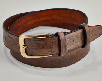 May include: A brown leather belt with a brass buckle. The belt has a distressed look and is made of high-quality leather.